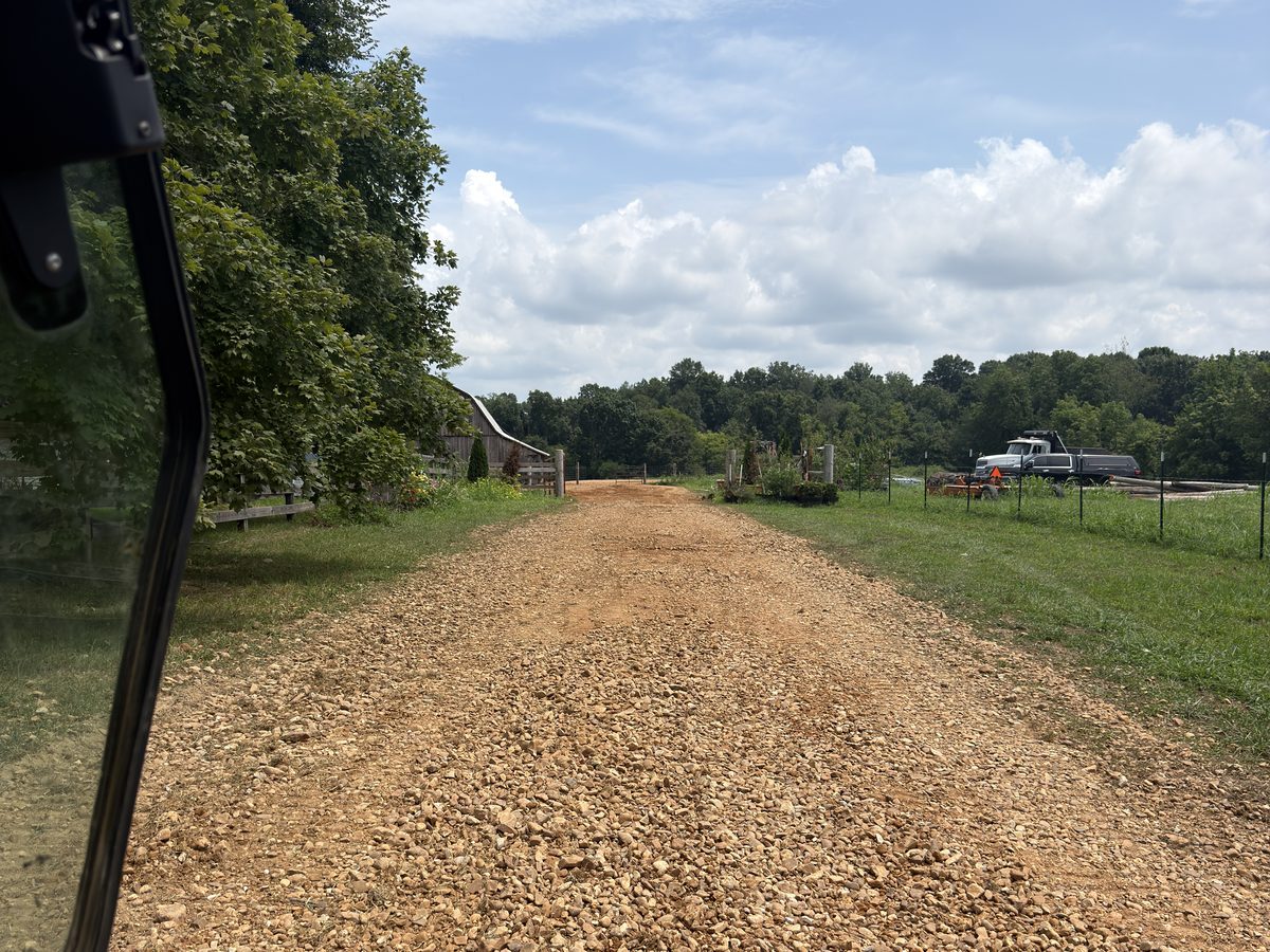 Same lane after power raking, existing gravel reclaimed to the surface and crowned, no new stone added